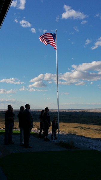 Bo and his family raise a flag in front of the house for the first time.